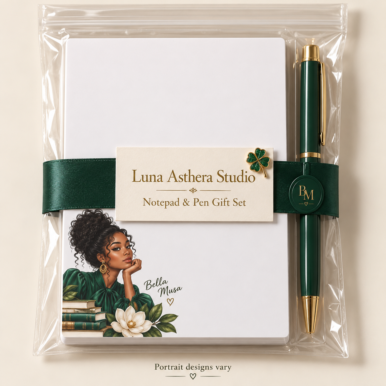 Packaging mockup of a Bella Musa portrait notepad and green-and-gold pen in a clear sleeve, with forest-green ribbon, BM seal, branded presentation card and four-leaf clover pin; portrait and pen appearance vary